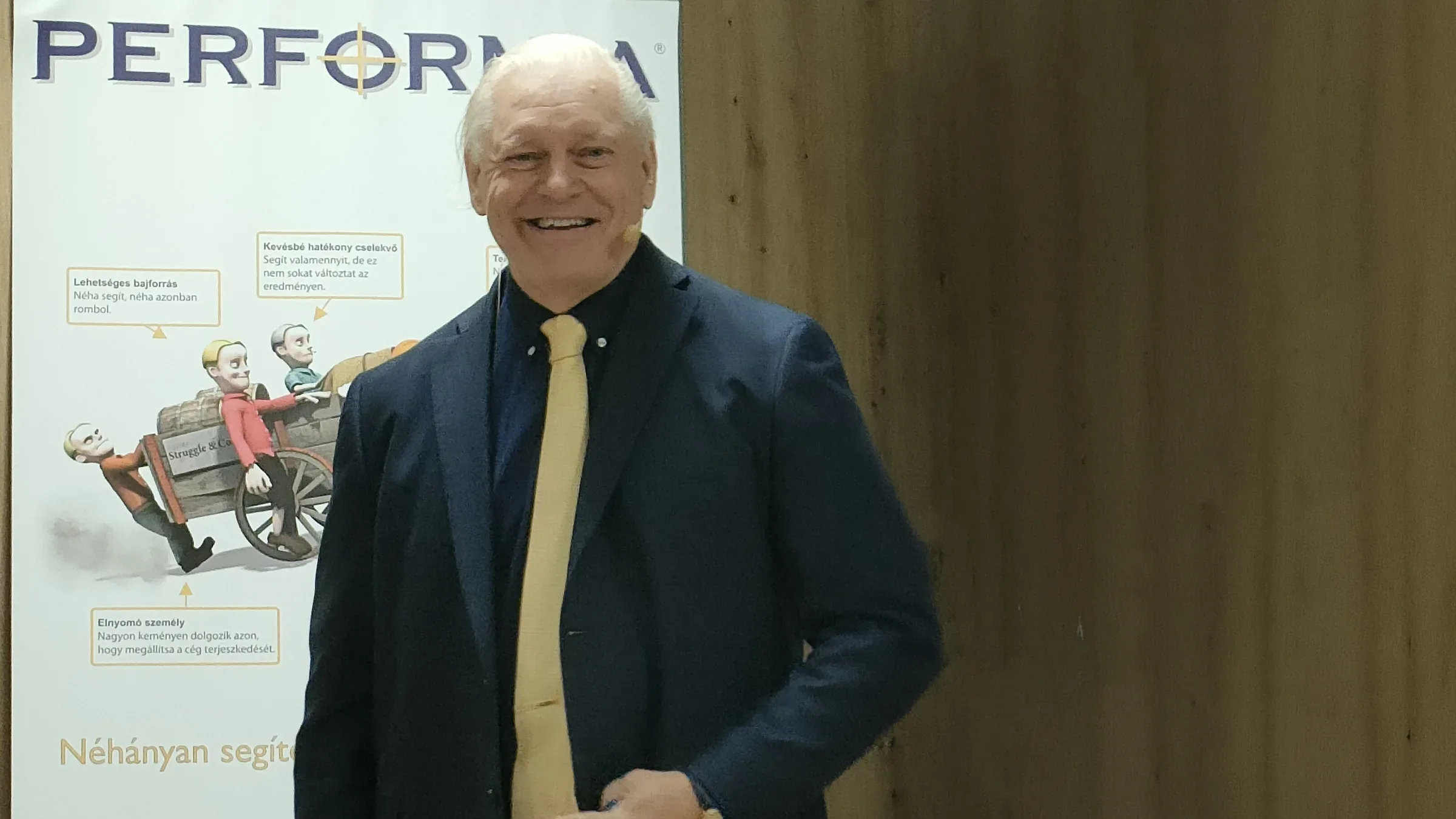 Mårten Runow smiling in front of a Performia banner